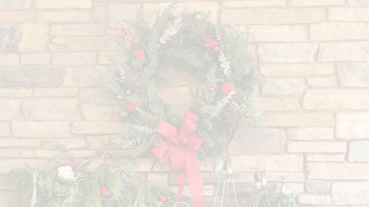 A Christmas wreath on a brick wall