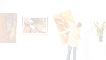 A man hanging up a large canvas artwork on a wall