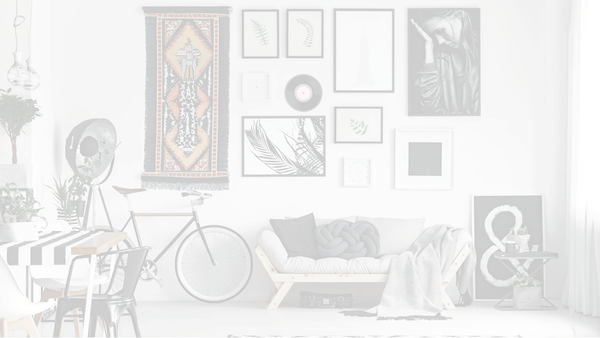 Darkened image of a gallery wall hung using push pins