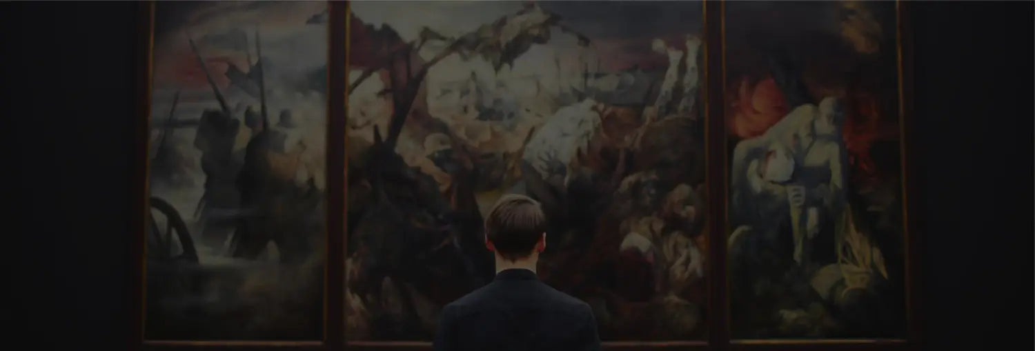 man staring at a painting