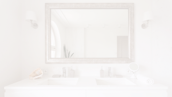 a minimalist bedroom with a round mirror on a white wall 