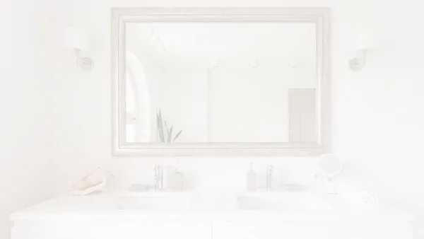 a minimalist bedroom with a round mirror on a white wall 