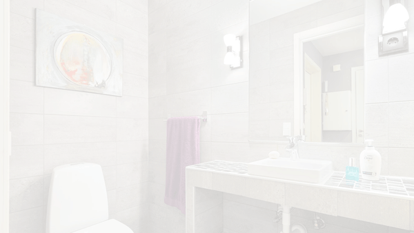 Darkened image of a bathroom with a  picture on the wall