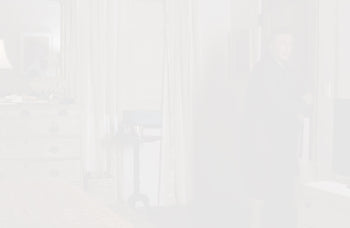 whitened still from the movie 'it's complicated' showing wall art reflected on a mirror above a dresser