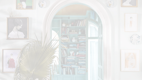 A room with a door and framed art on the wall.