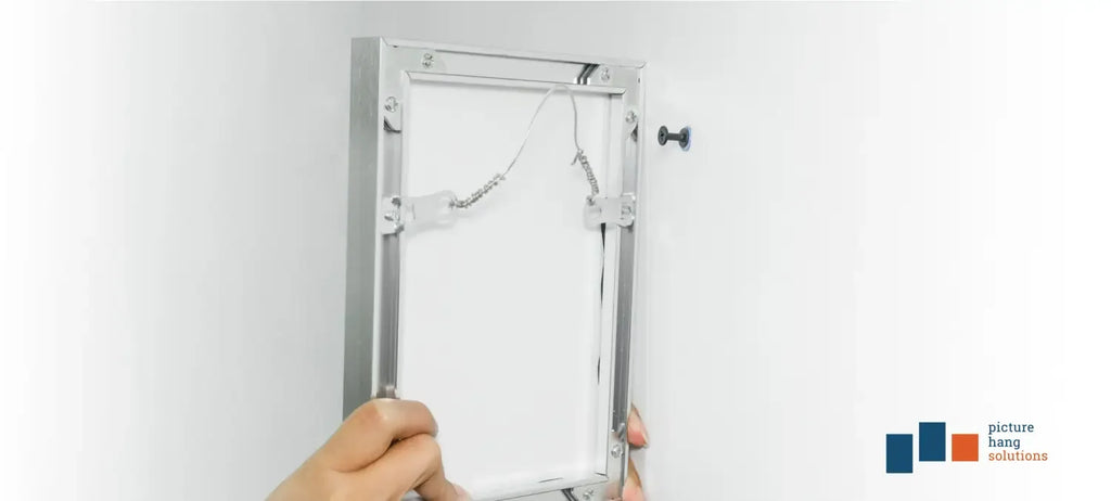 Picture hangers at back of a metal frame