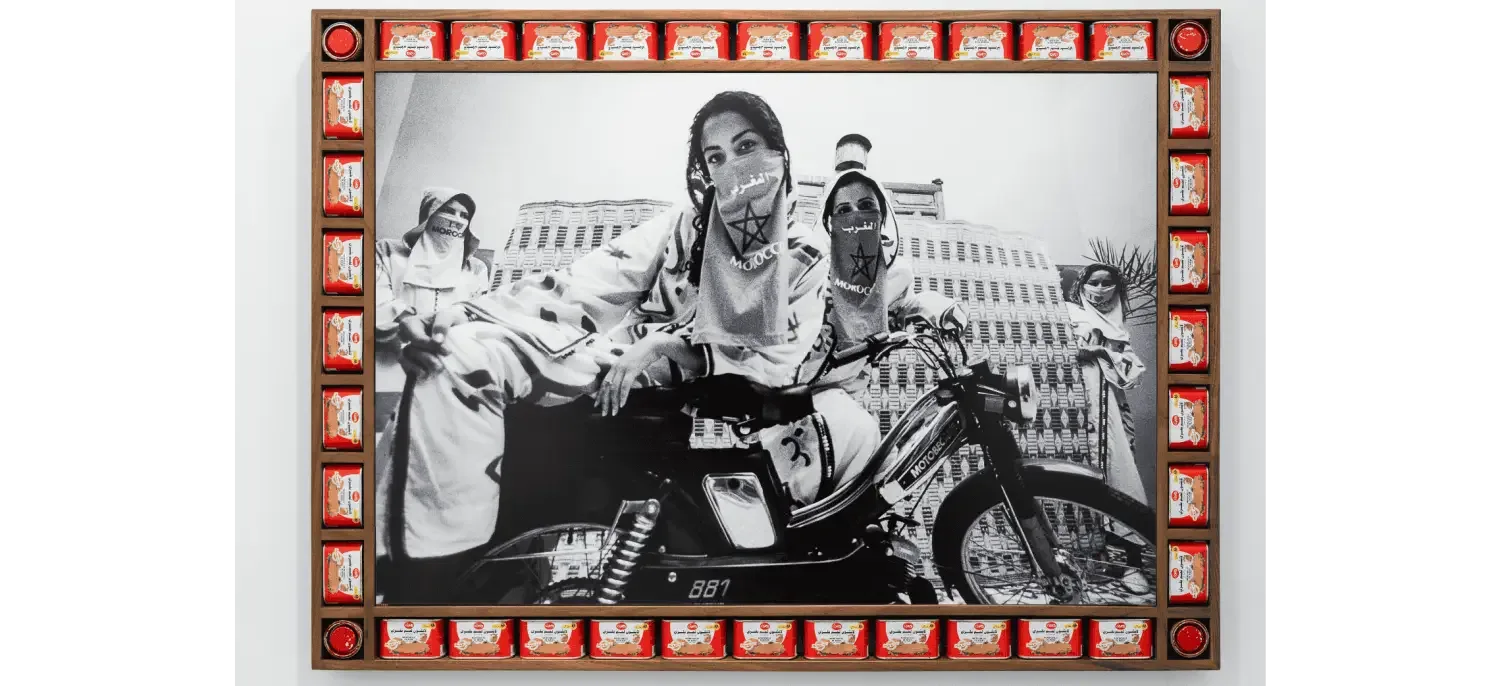 Black and white photograph of a woman on a bike