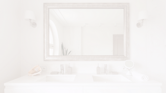 a minimalist bedroom with a round mirror on a white wall 