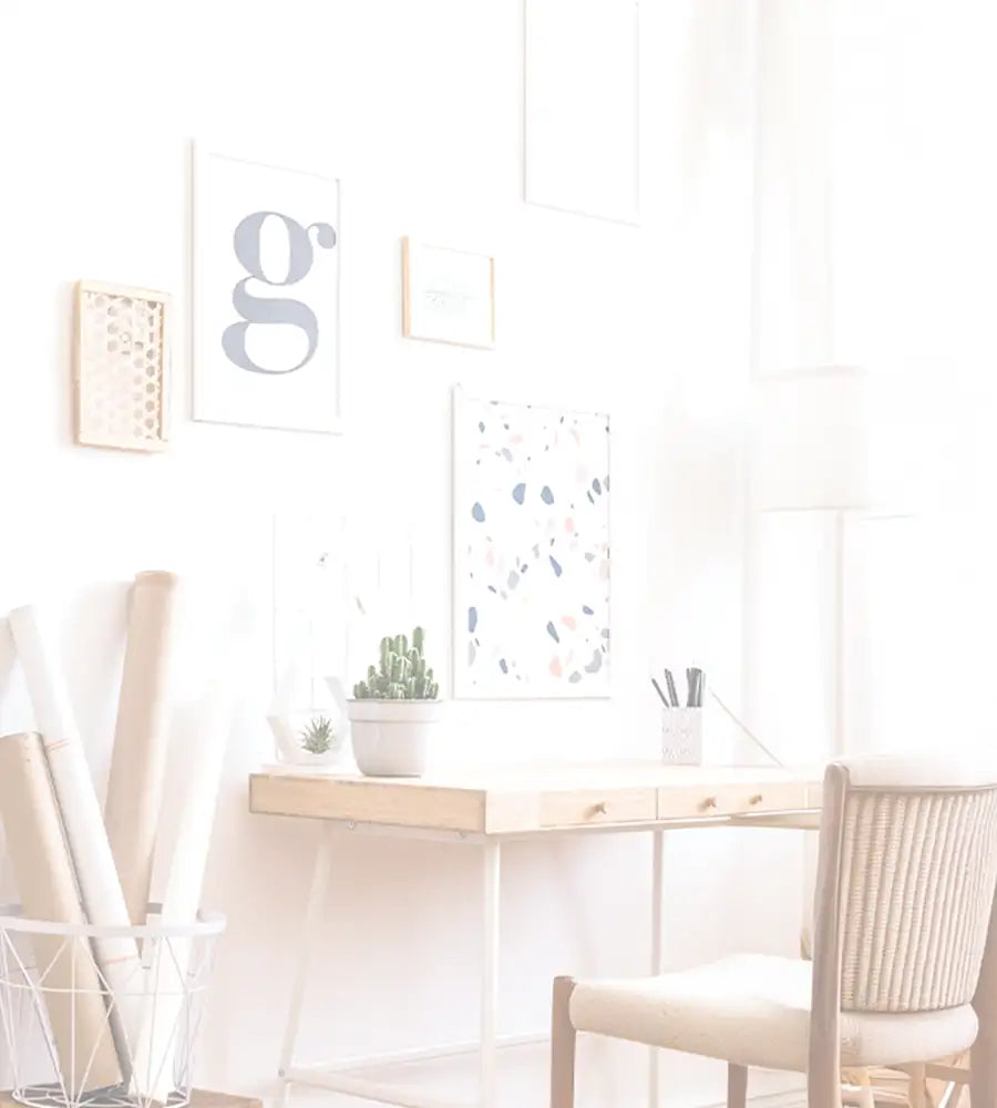 Minimalist wooden desk with white metal legs and two drawers, featuring a small potted cactus on its surface.