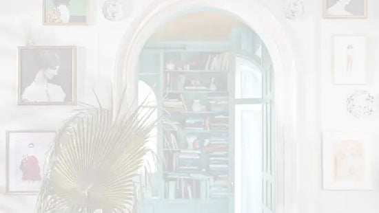 A room with a door and framed art on the wall.